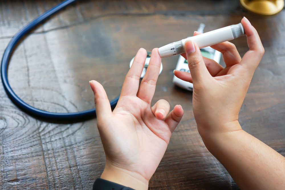 Woman testing her blood sugar.