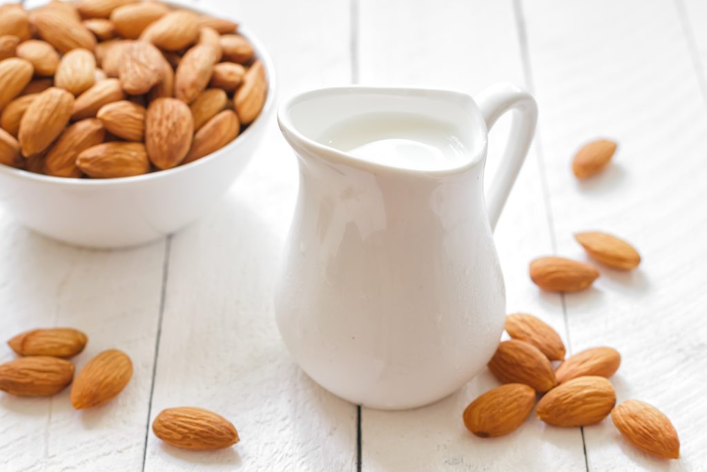 Almond milk on white background.