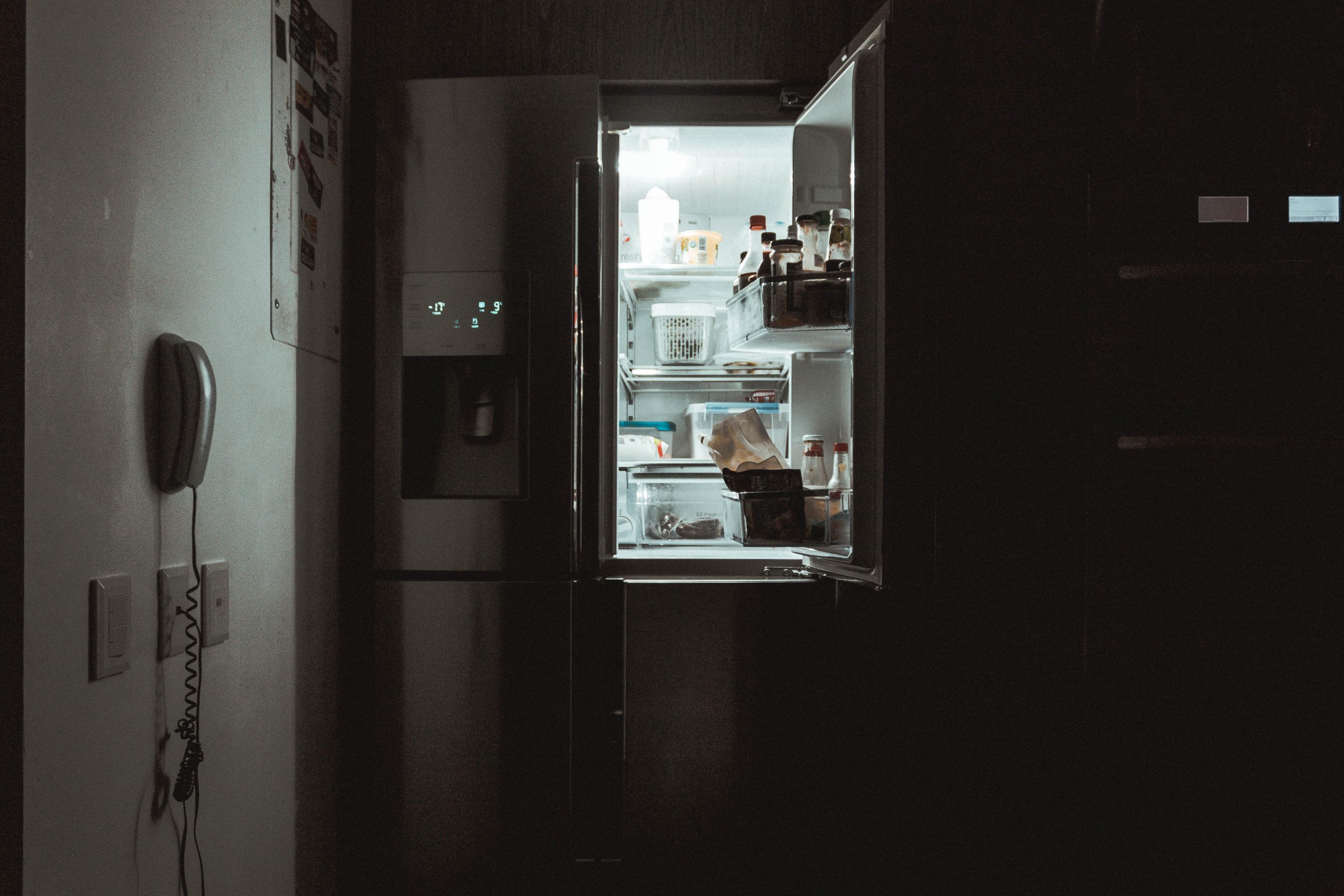Open fridge at night.