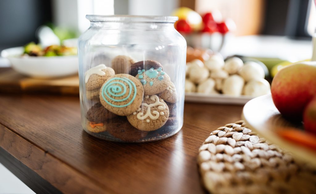 Beautiful tasty cookies in jar on kitchen table at home
