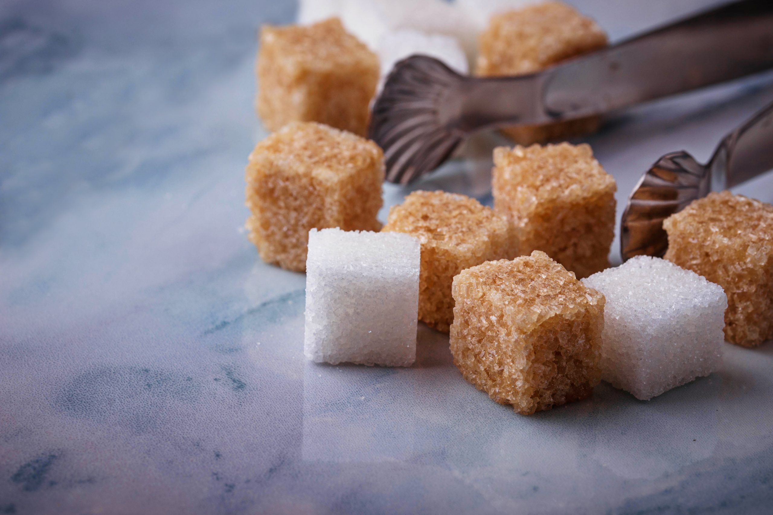 White and brown sugar. Selective focus