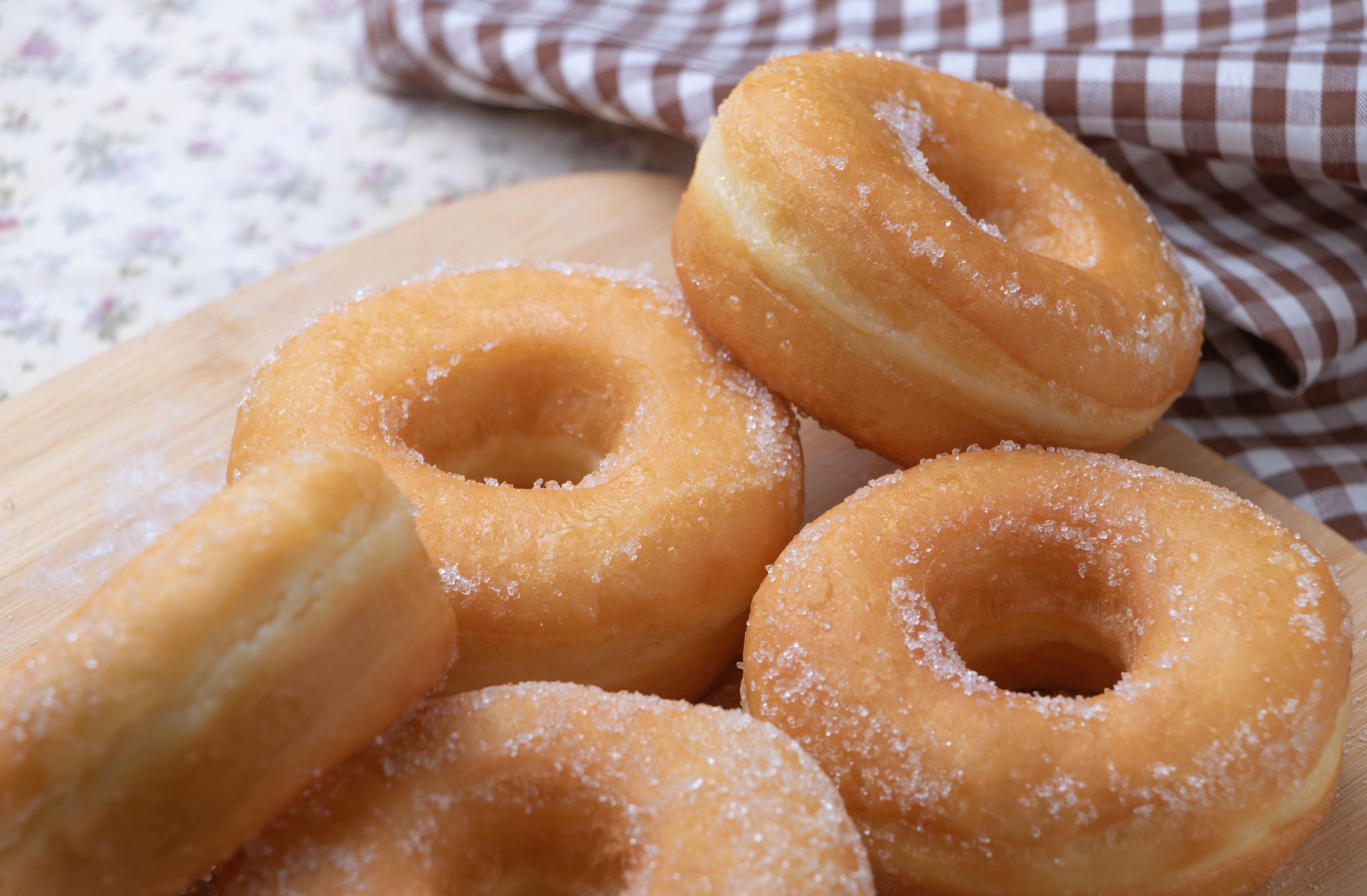 Sugar donuts on wooden board