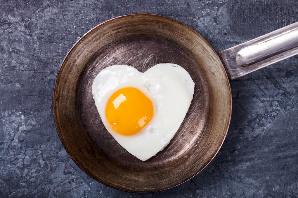 Fried egg in heart shape on the pan.Holiday Valentine's Day.Breakfast. Healthy Food.