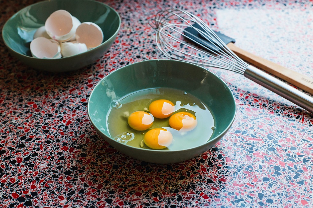 Raw eggs and a whisk. 