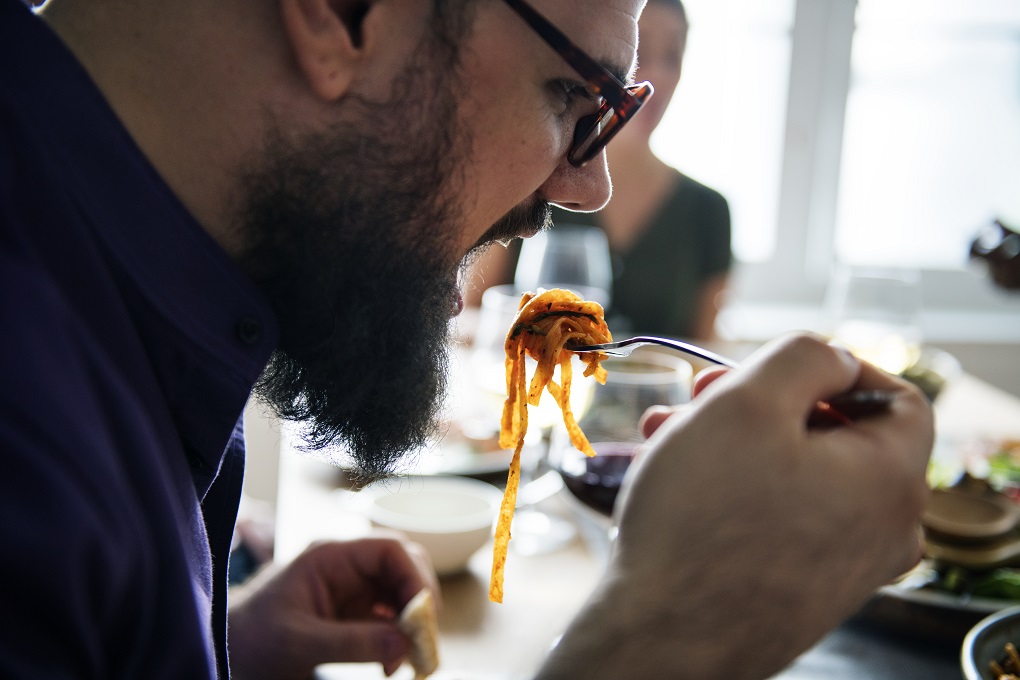 Man eating pasta.