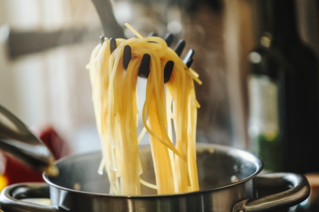 Closeup of boiling spaghetti pasta in pot.