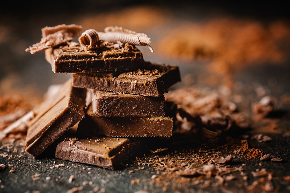 Closeup of dark chocolate bars and cocoa powder.