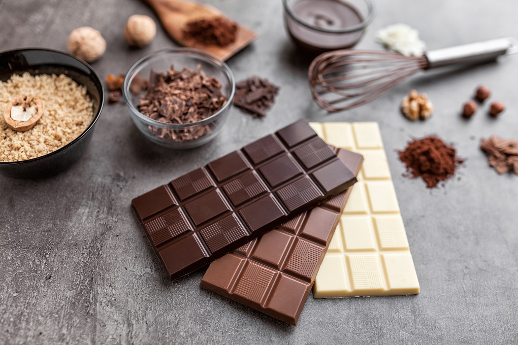Delicious and sweet variety of chocole on rustic background