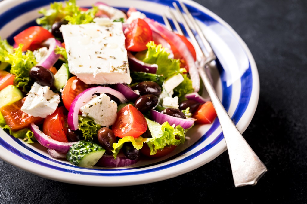 Greek salad of fresh vegetables, olives and feta. Traditional Mediterranean food. Vitamins. Healthy food concept.