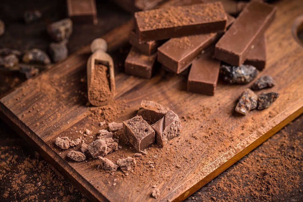 Homemade chocolate bars on wooden background