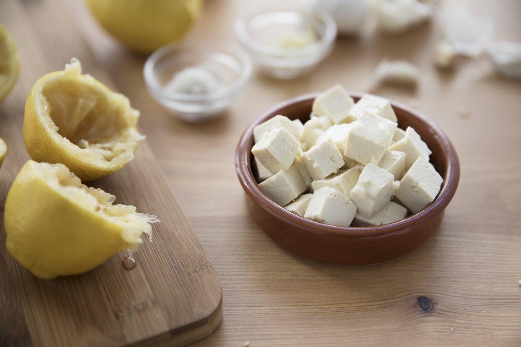Tofu, lemons, garlic and salt for marinaded tofu for salads.
