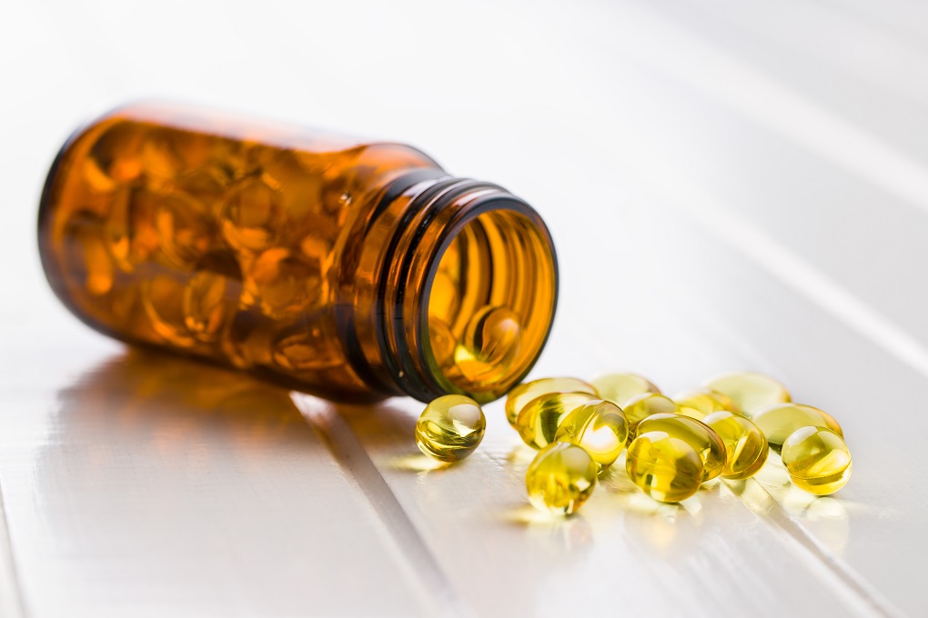 Omega 3 gel capsules in glass bottle.