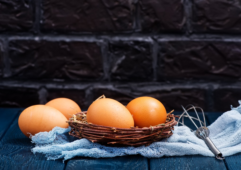 raw chicken egg on the kitchen table