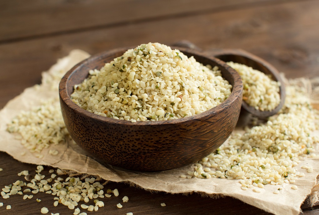 Pile of Uncooked Hemp seeds in a bowl with a spoon